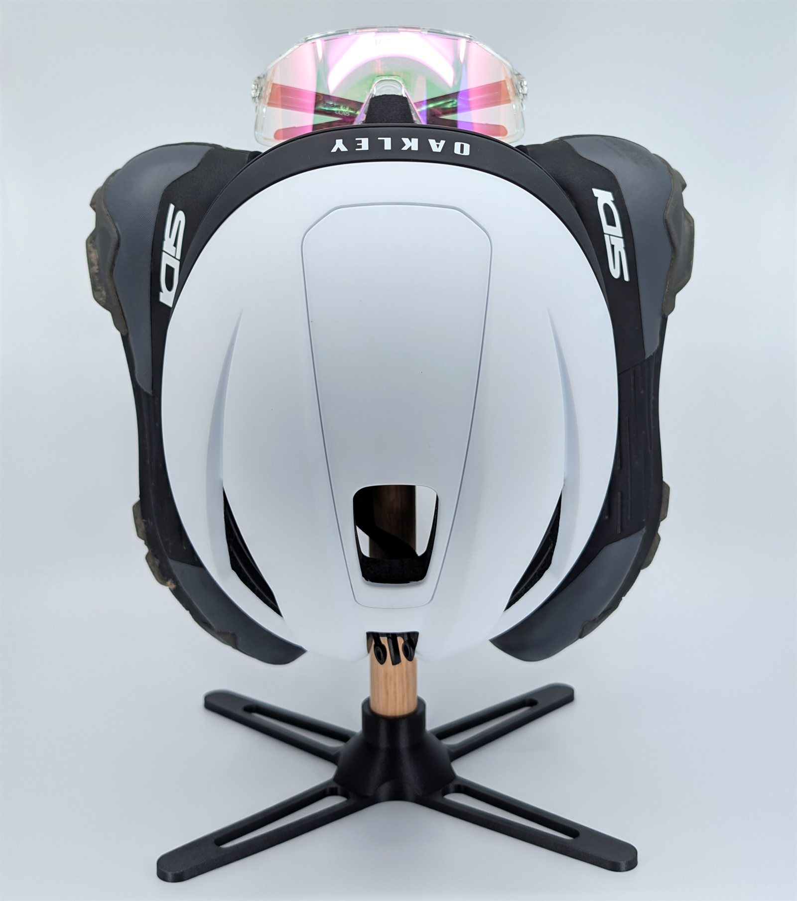 The Compact All-in-One Stand holding a helmet, shoes and sunglasses.